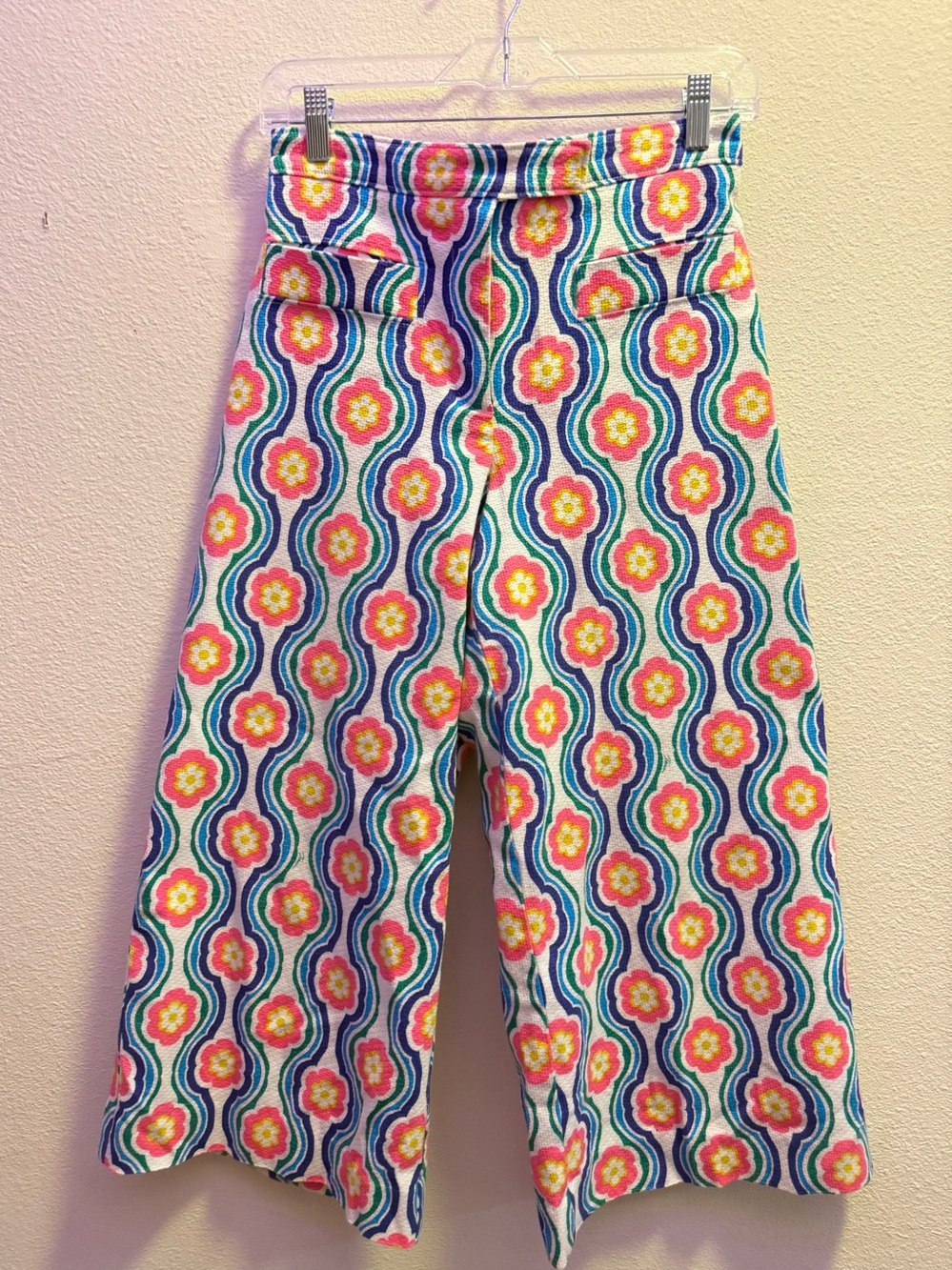 Trina Turk Lulu pants featuring a vibrant, multicolored floral and wavy pattern